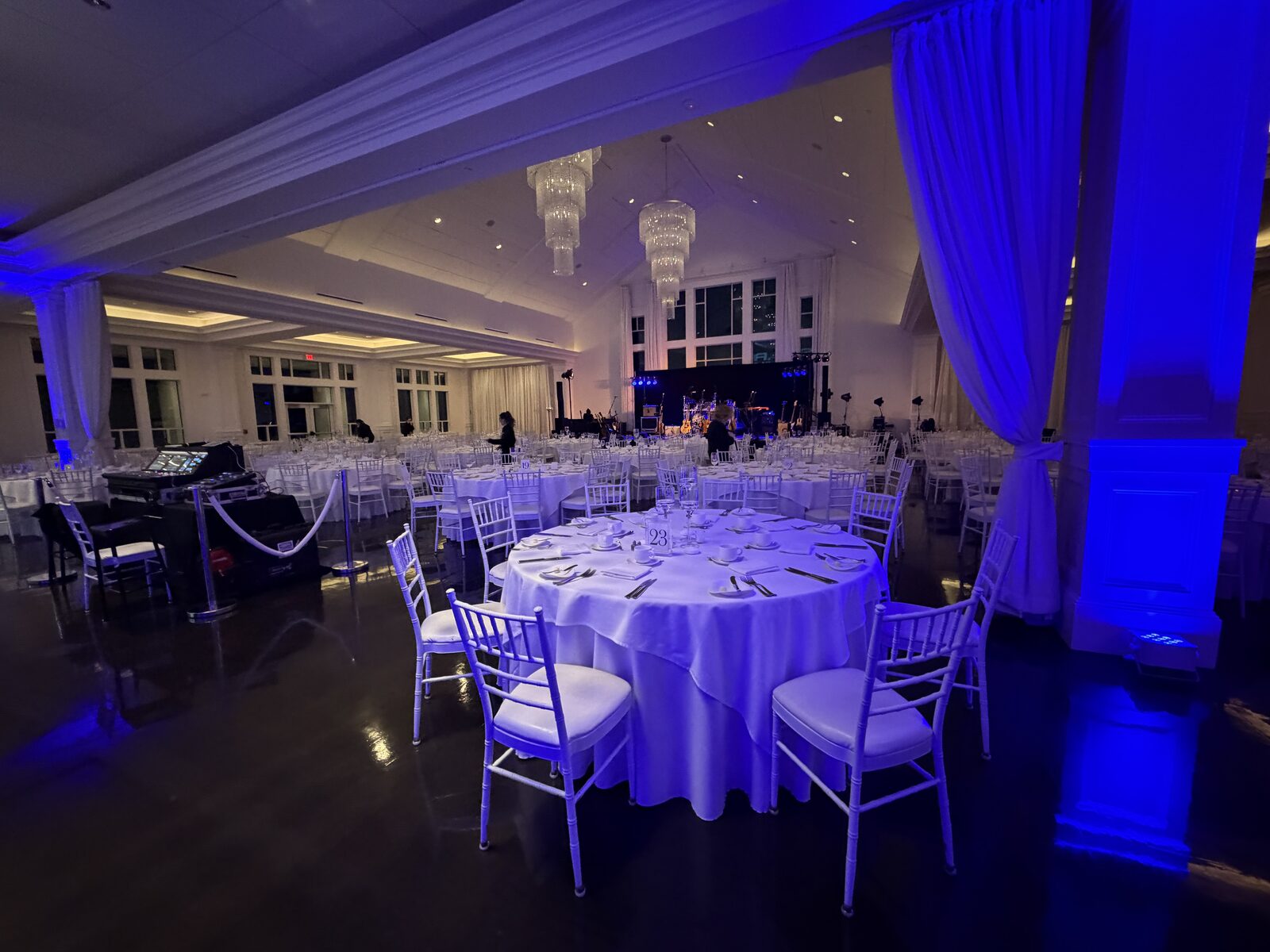 Elegant gala venue with white drape and blue uplighting